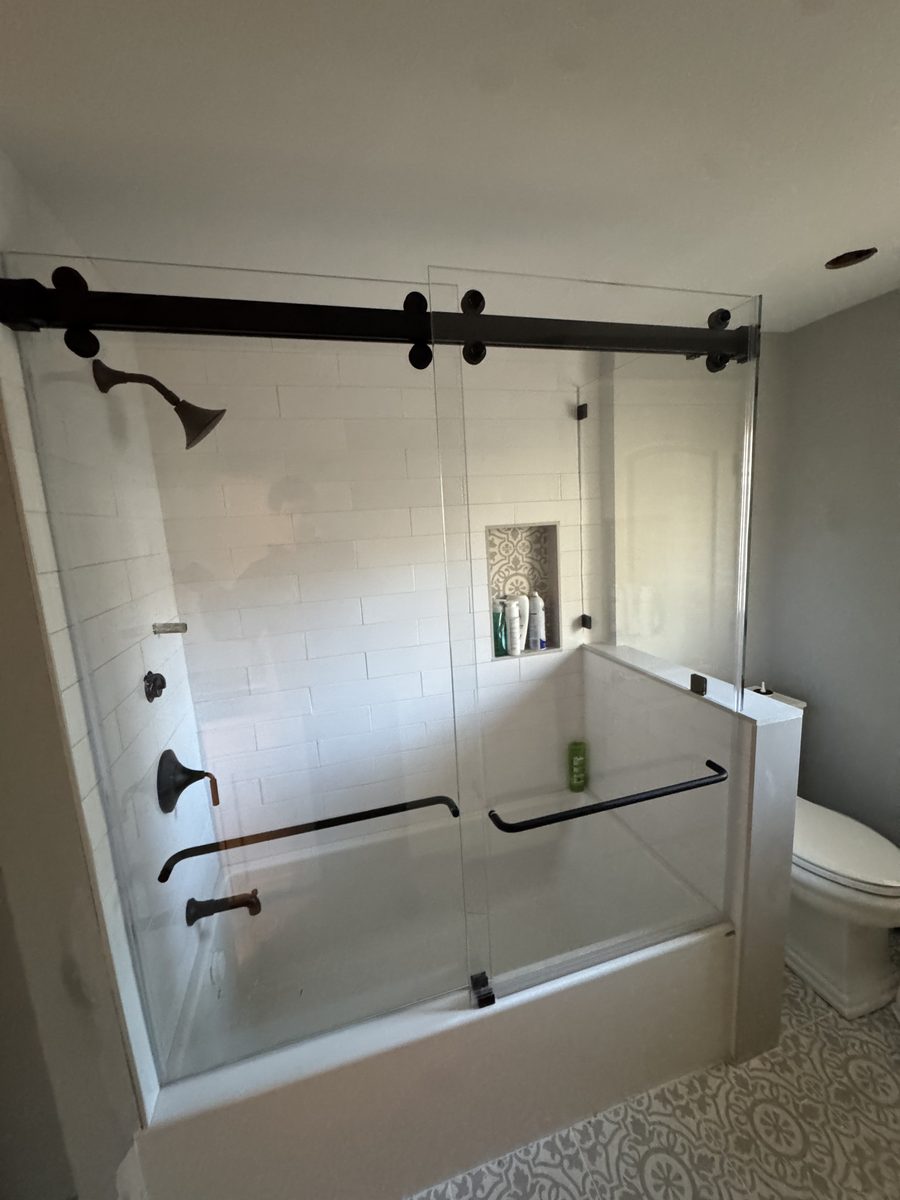 glass tub enclosure with matte black sliding hardware North Shore MA