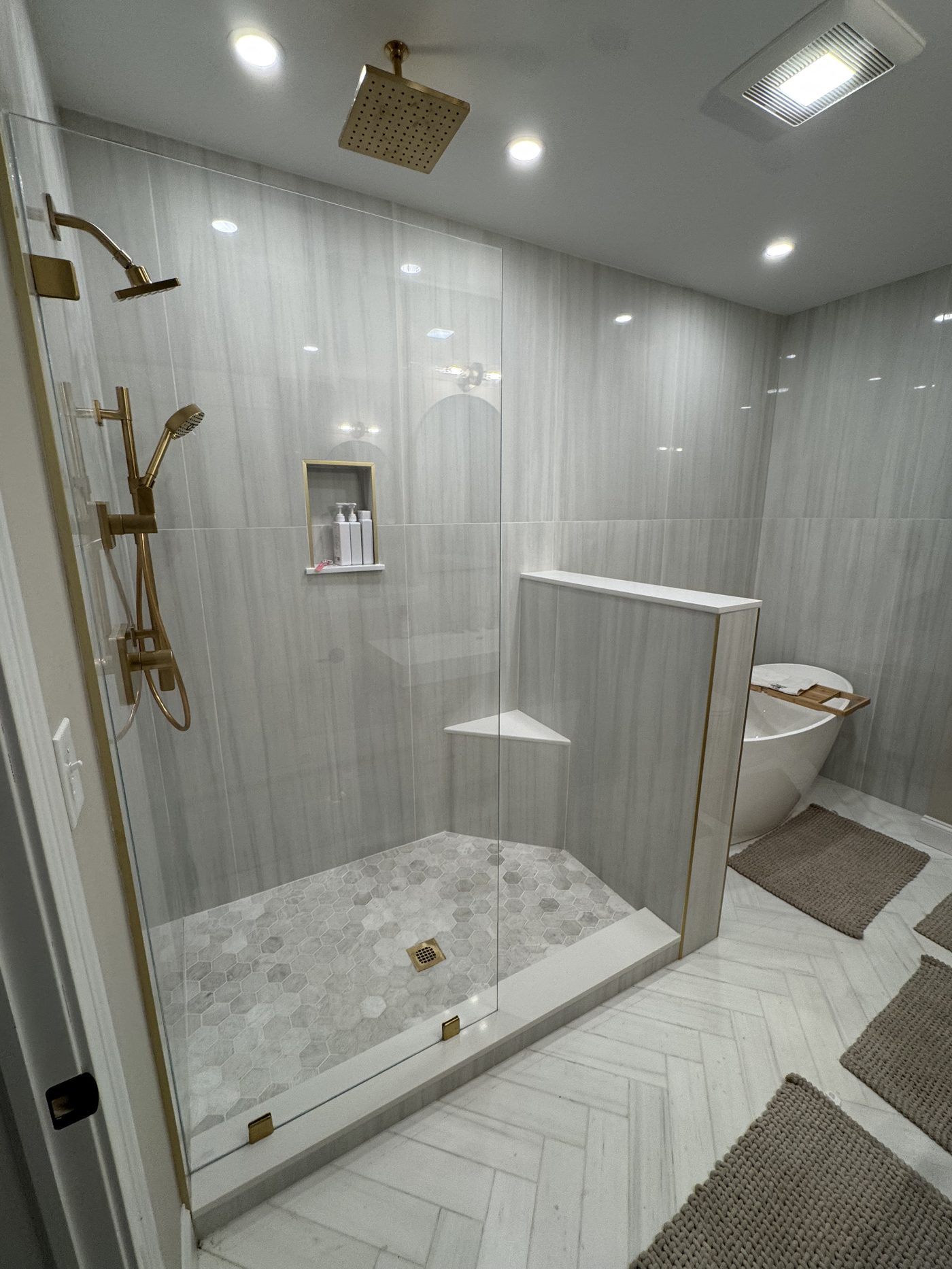 luxury frameless walk-in shower door installation with brushed gold hardware serving Peabody MA and North Shore
